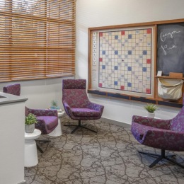 a loft area with chairs and a window