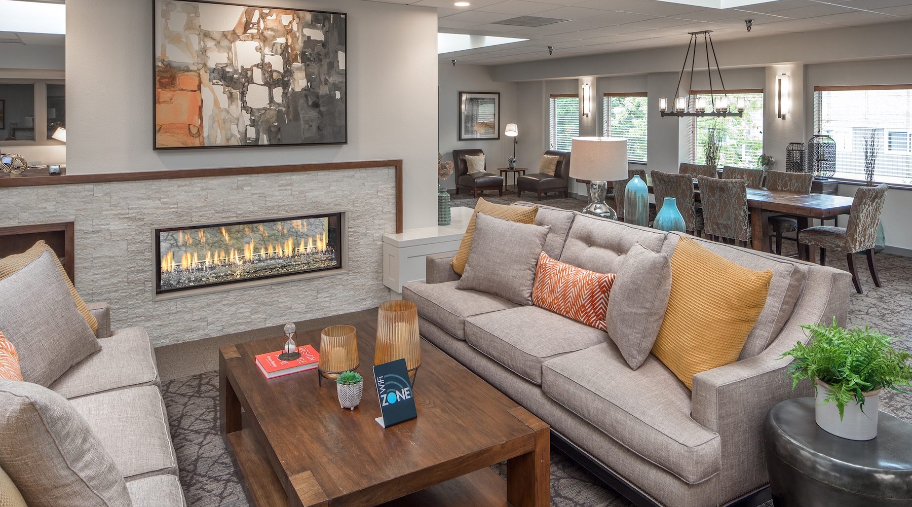 a clubroom with a fireplace, coffee table and couches