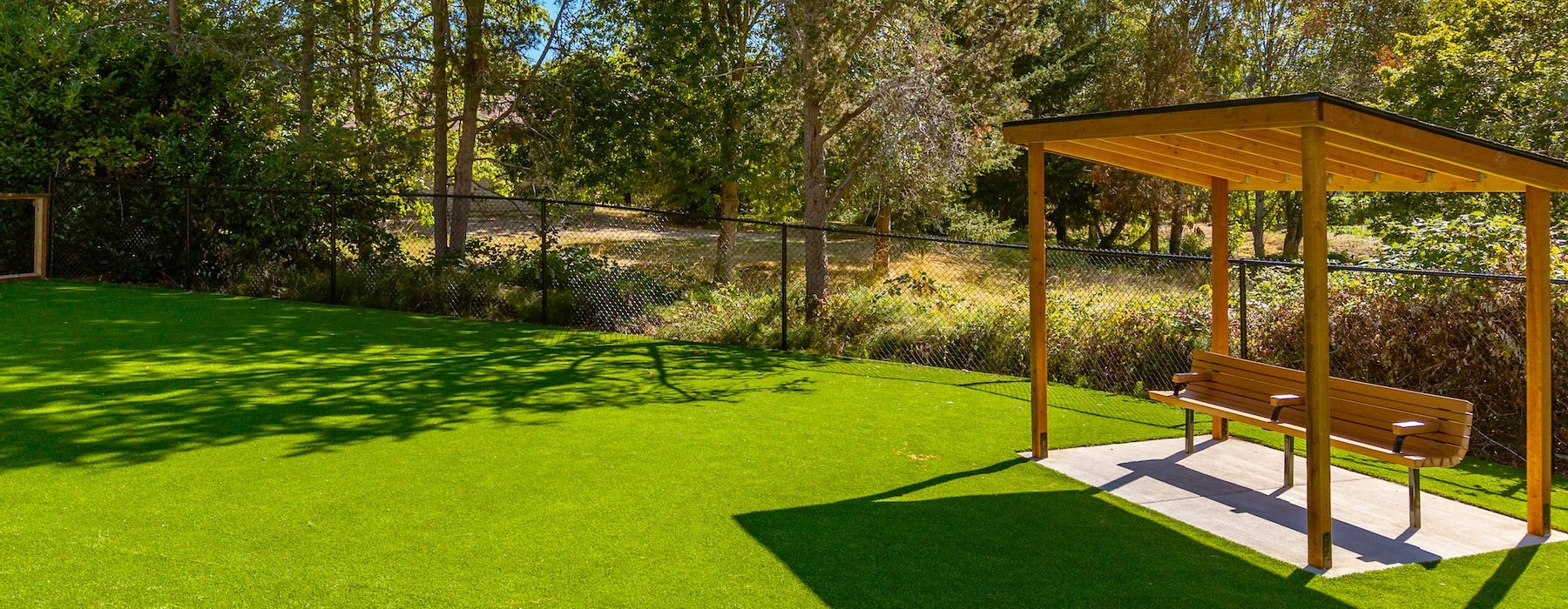 a dog park with a covered seating area