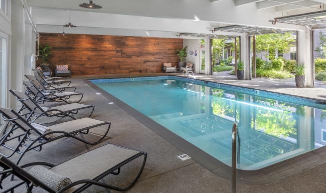 a swimming pool with chairs around it