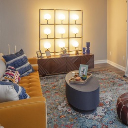 a living room with a couch, tables and chairs