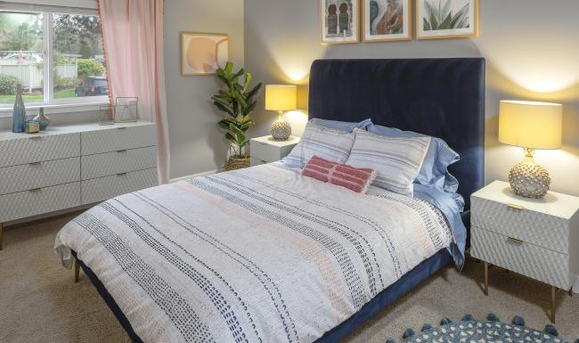a bedroom with a bed and dressers