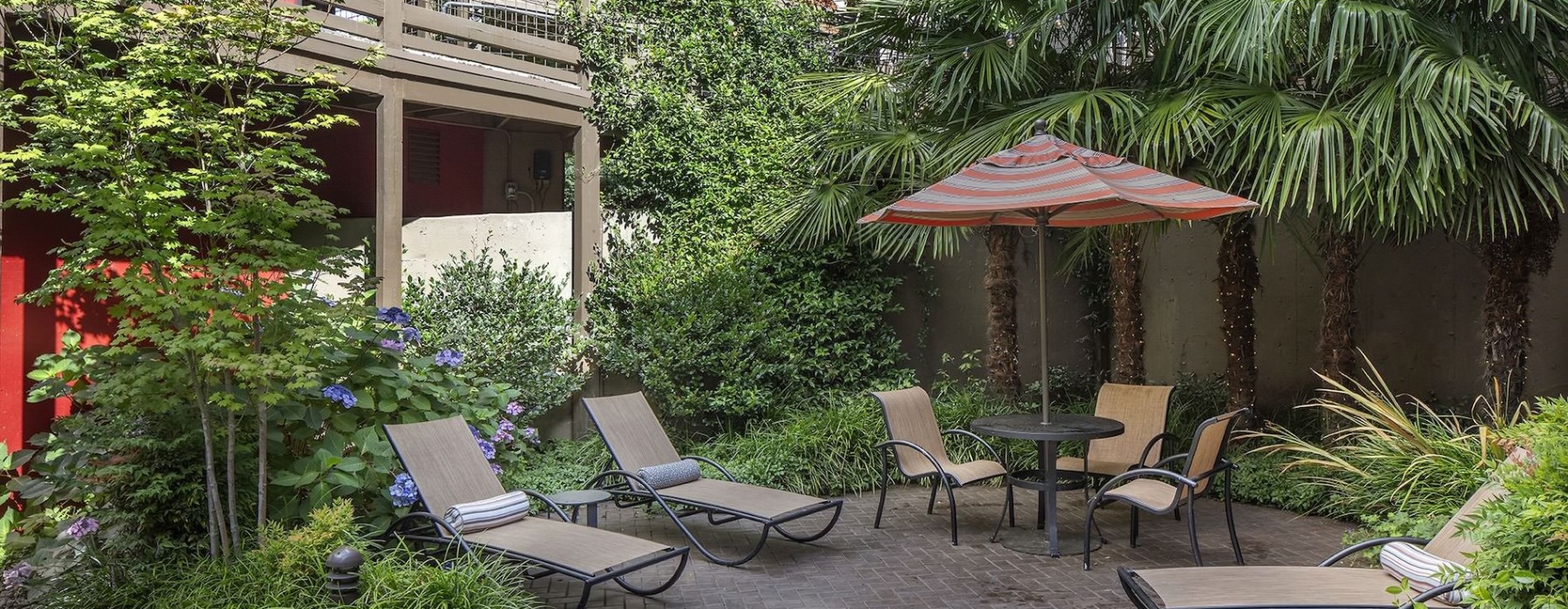 a patio with chairs and umbrella